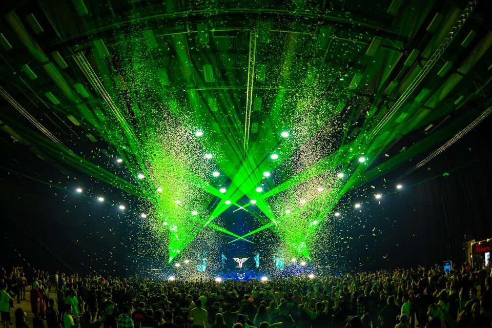 Green lasers and confetti storm across the arena
