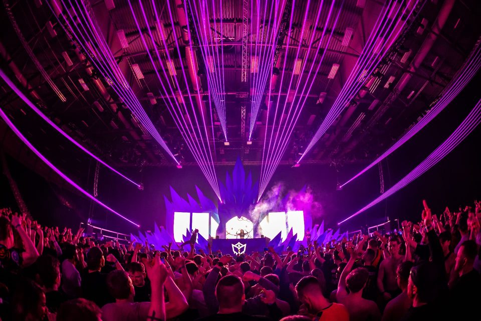 Purple lasers filling the arena above the crowd