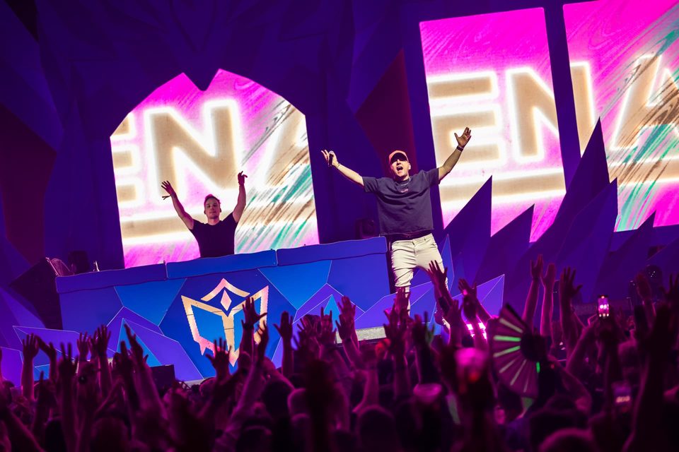 Artist and MC on stage in front of the crowd